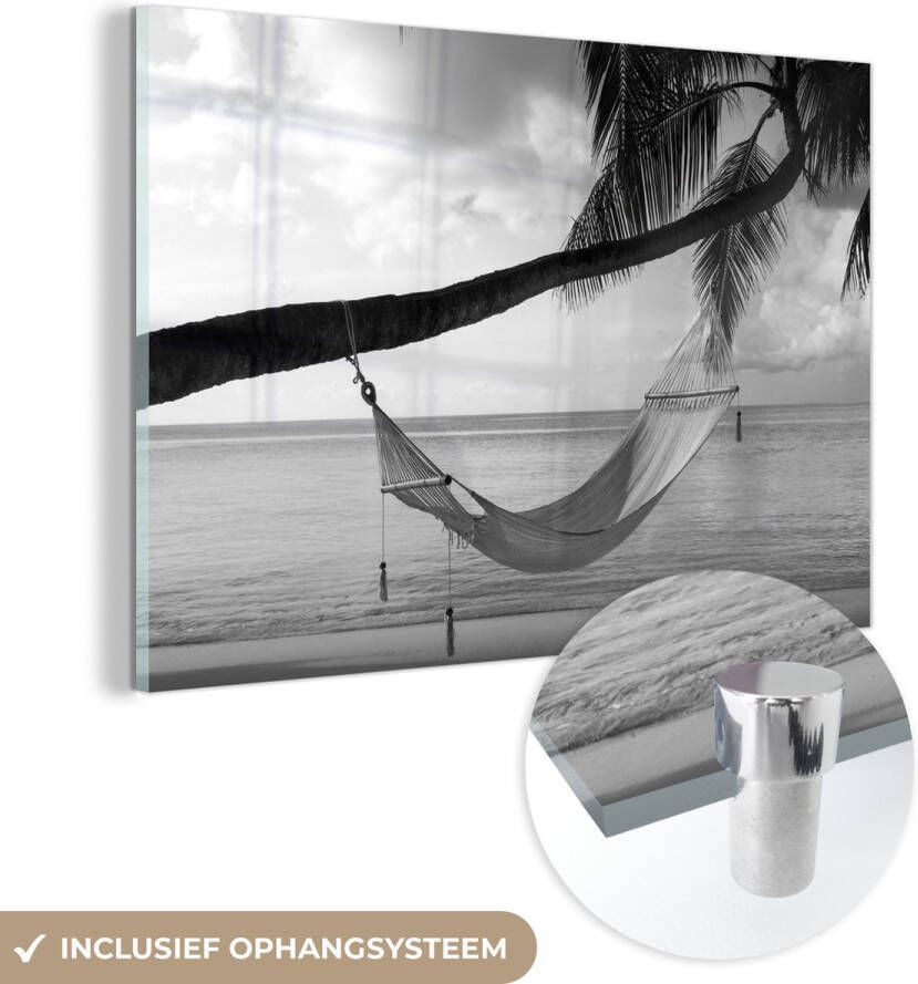 MuchoWow Glasschilderij 120x80 cm Schilderij acrylglas Hangmat vastgeknoopt aan een palmboom bij een strand zwart wit Foto op glas Schilderijen