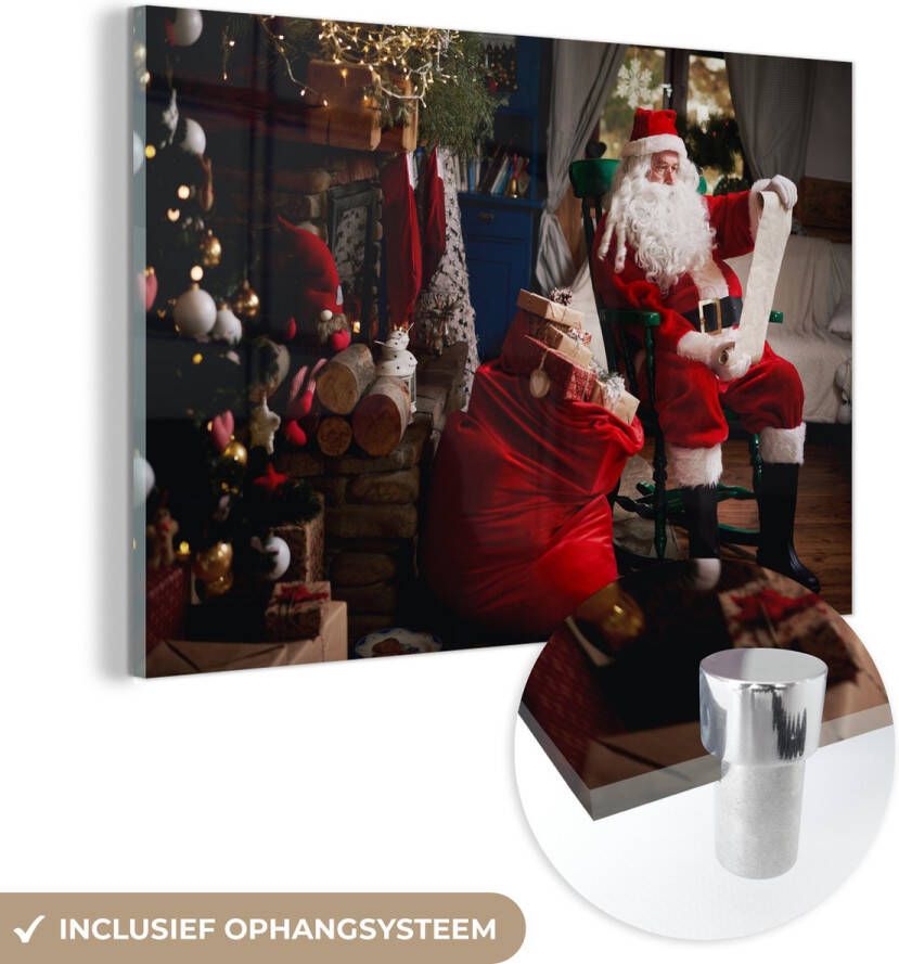 MuchoWow Glasschilderij 150x100 cm Schilderij acrylglas De kerstman zittend in een stoel met zak vol geschenken Foto op glas Schilderijen