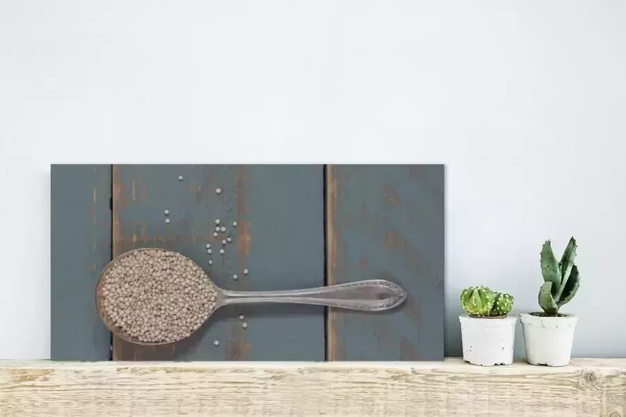 MuchoWow Glasschilderij Een vintage lepel met quinoa op een houten tafel 40x20 cm Acrylglas Schilderijen Foto op Glas