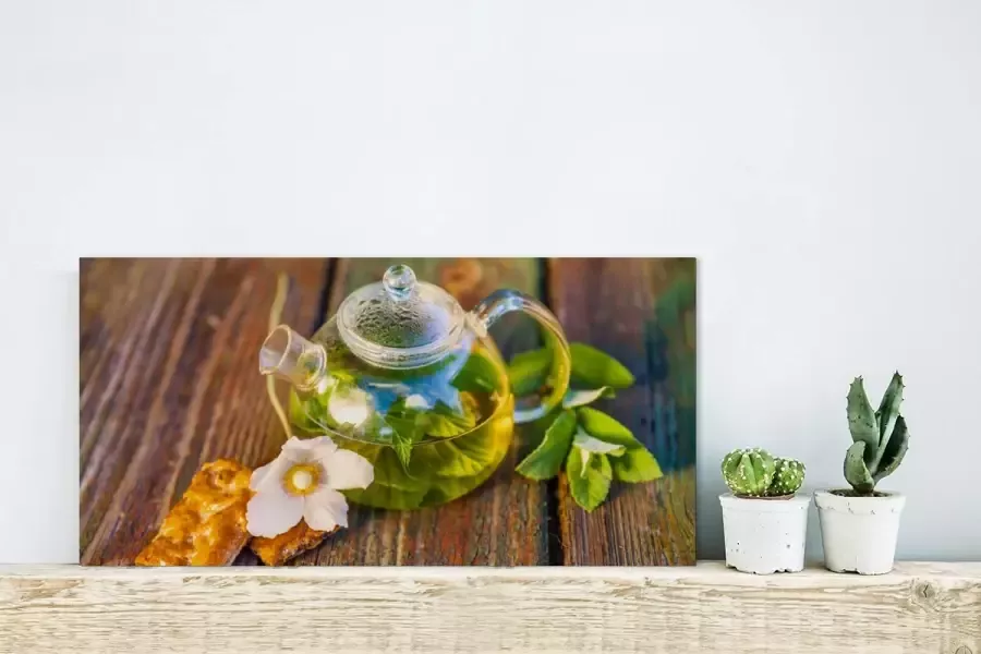 MuchoWow Glasschilderij Glazen theepot op een houten tafel 40x20 cm Acrylglas Schilderijen Foto op Glas