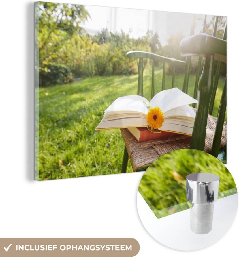 MuchoWow Glasschilderij 90x60 cm Schilderij glas Stoel met een boek in de tuin Foto op acrylglas Schilderijen