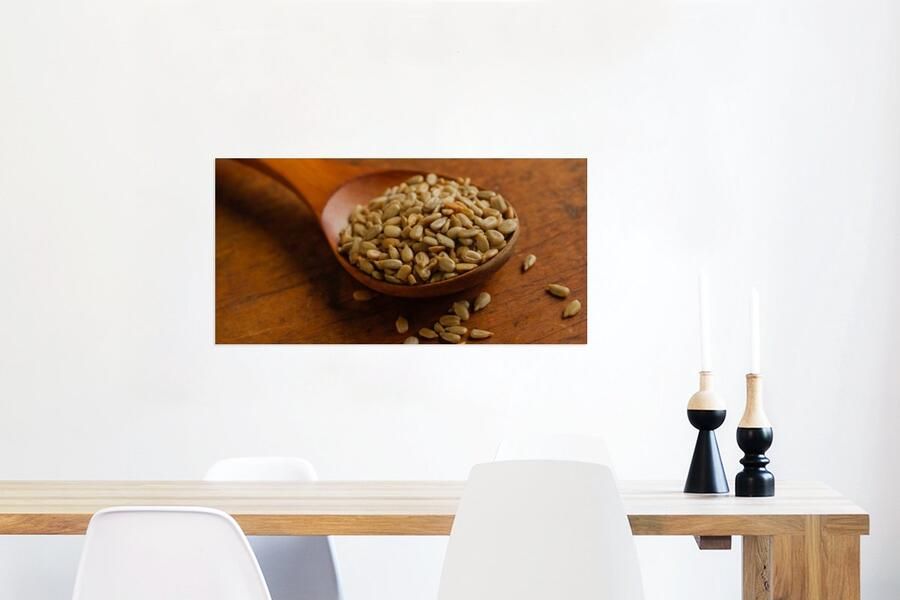 MuchoWow Glasschilderij Houten lepel vol met zonnebloempitten op houten tafel 80x40 cm Acrylglas Schilderijen Foto op Glas