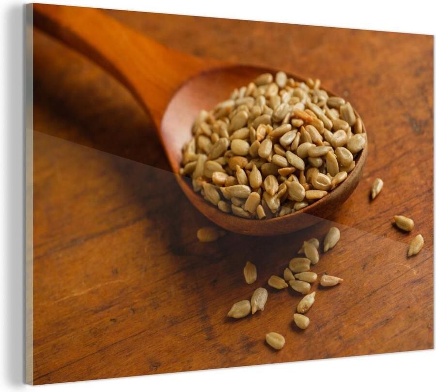 MuchoWow Glasschilderij Houten lepel vol met zonnebloempitten op houten tafel 90x60 cm Acrylglas Schilderijen Foto op Glas