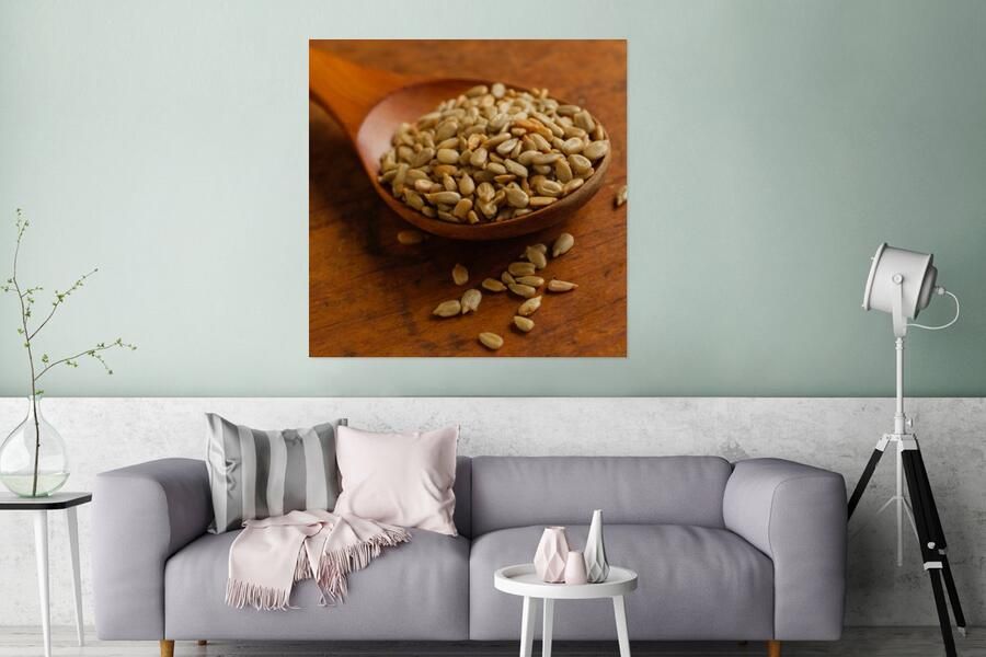 MuchoWow Glasschilderij Houten lepel vol met zonnebloempitten op houten tafel 90x90 cm Acrylglas Schilderijen Foto op Glas
