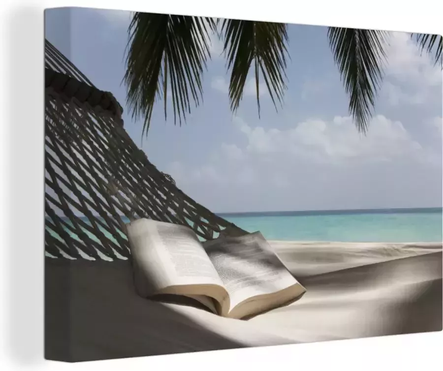 OneMillionCanvasses Canvas schilderij 140x90 cm Wanddecoratie Boek in een hangmat op een tropisch eiland Muurdecoratie woonkamer Slaapkamer decoratie Kamer accessoires Schilderijen