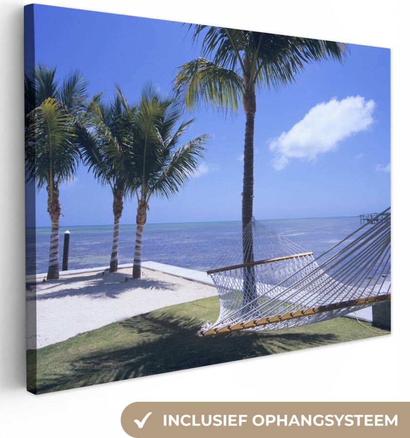 OneMillionCanvasses Canvas Schilderij Zee Hangmat Palmboom 80x60 cm Wanddecoratie