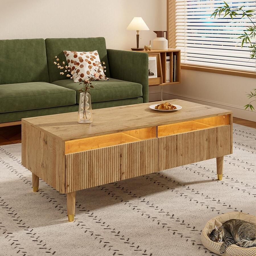 Pugsdrly Deze moderne salontafel met ledverlichting heeft een golvend blad met lades goudkleurige poten twee lades en een ledstrip die van kleur verandert