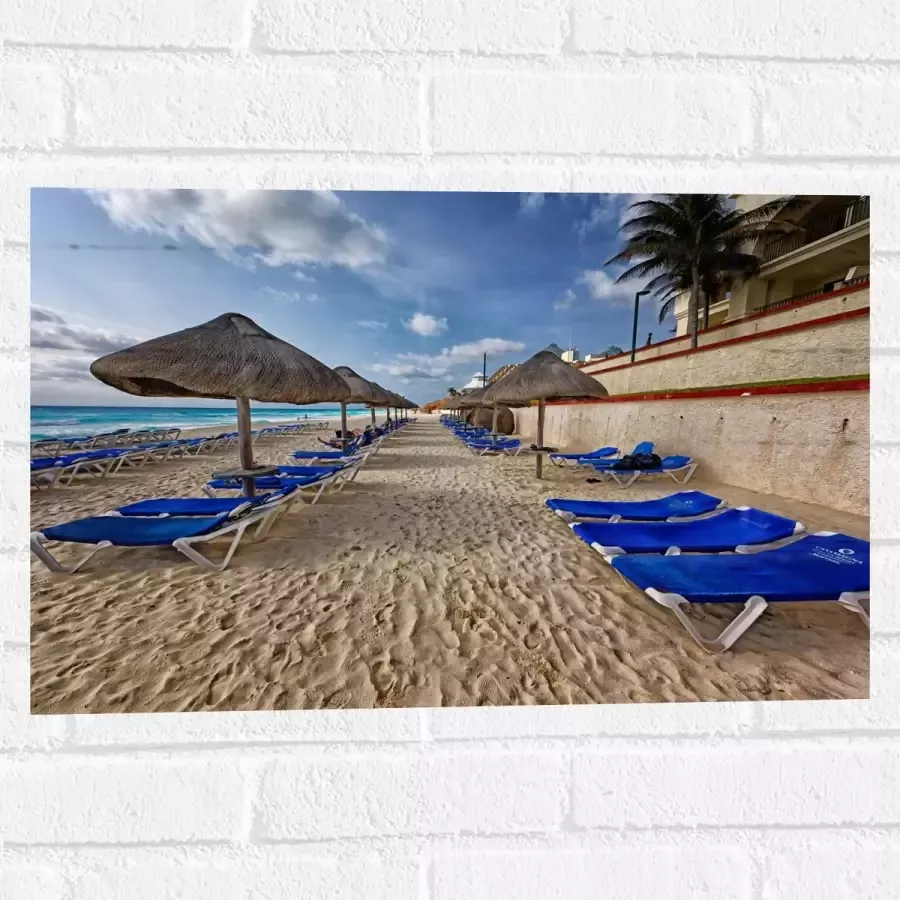 WallClassics Muursticker Blauwe Ligbedden op Strand met Rieten Parasols 60x40 cm Foto op Muursticker