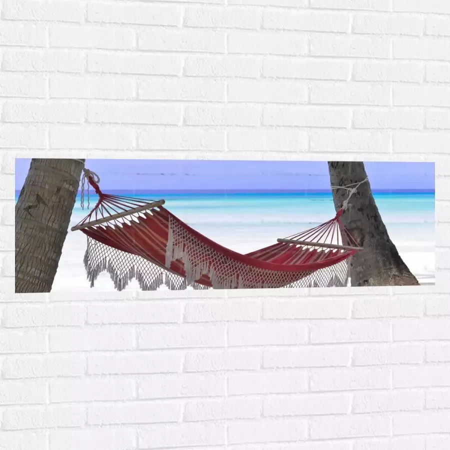 WallClassics Muursticker Rode Ibiza Hangmat op Tropisch Strand 120x40 cm Foto op Muursticker