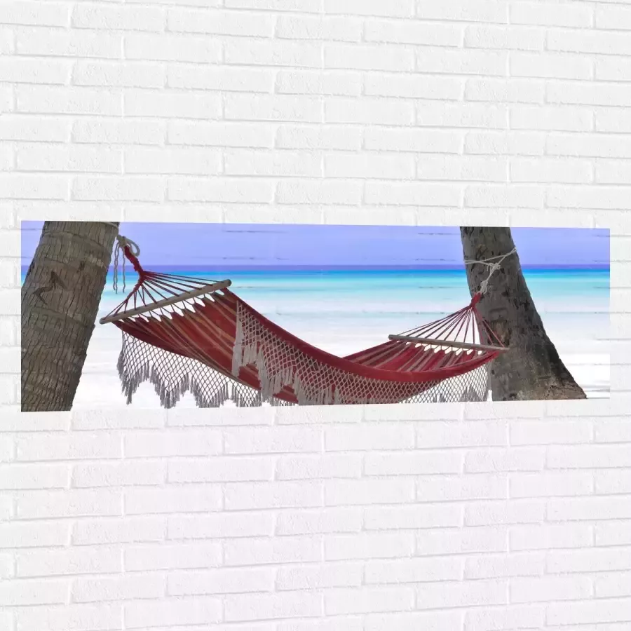 WallClassics Muursticker Rode Ibiza Hangmat op Tropisch Strand 150x50 cm Foto op Muursticker