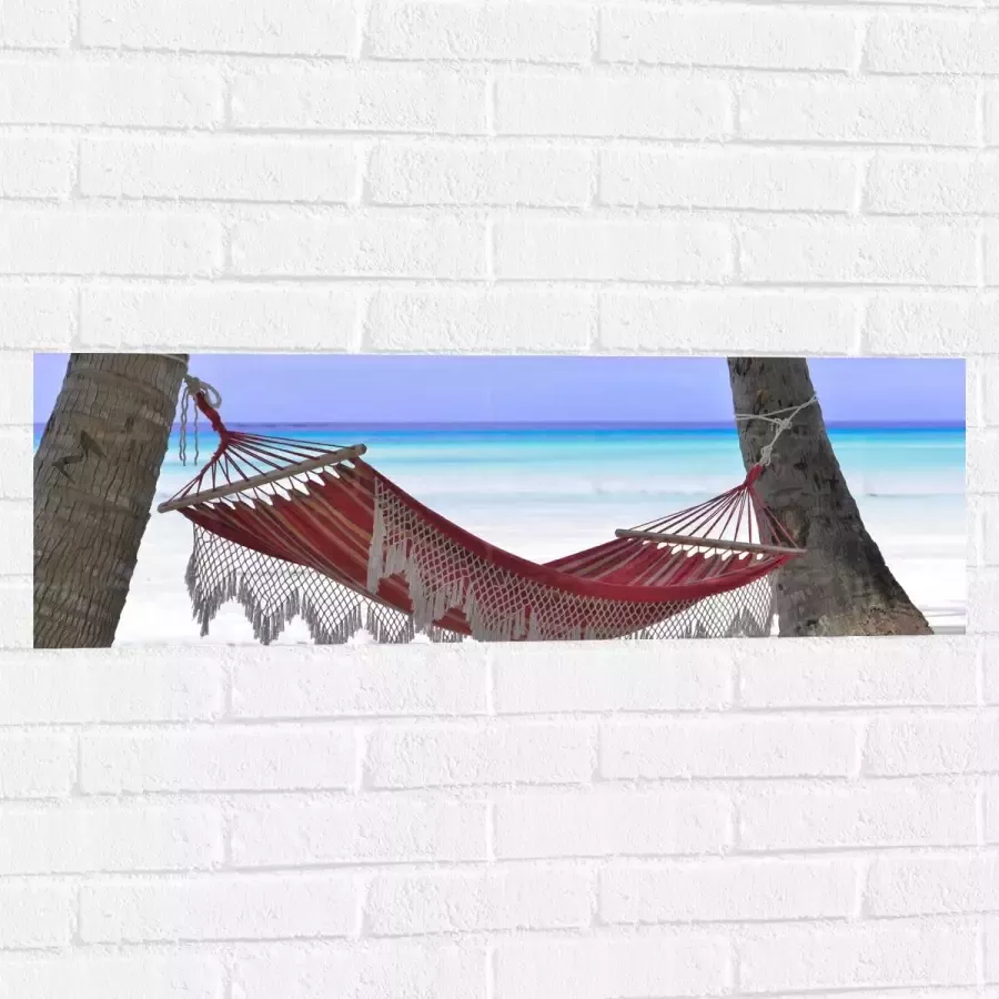 WallClassics Muursticker Rode Ibiza Hangmat op Tropisch Strand 90x30 cm Foto op Muursticker